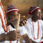 Close-up of hands playing a traditional wooden instrument