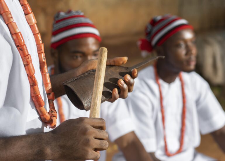 Close-up of hands playing a traditional wooden instrument